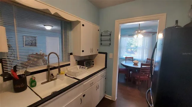 a kitchen with sink and cabinets