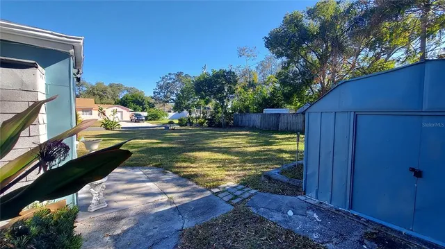 a view of a lake with houses in back