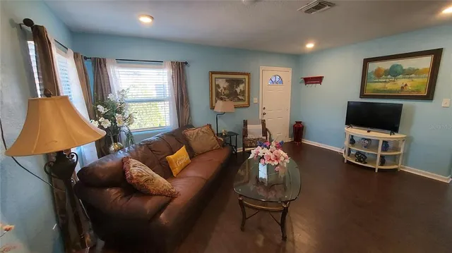 a living room with furniture and a flat screen tv