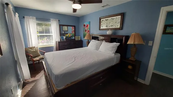a bed sitting in a bedroom next to a window