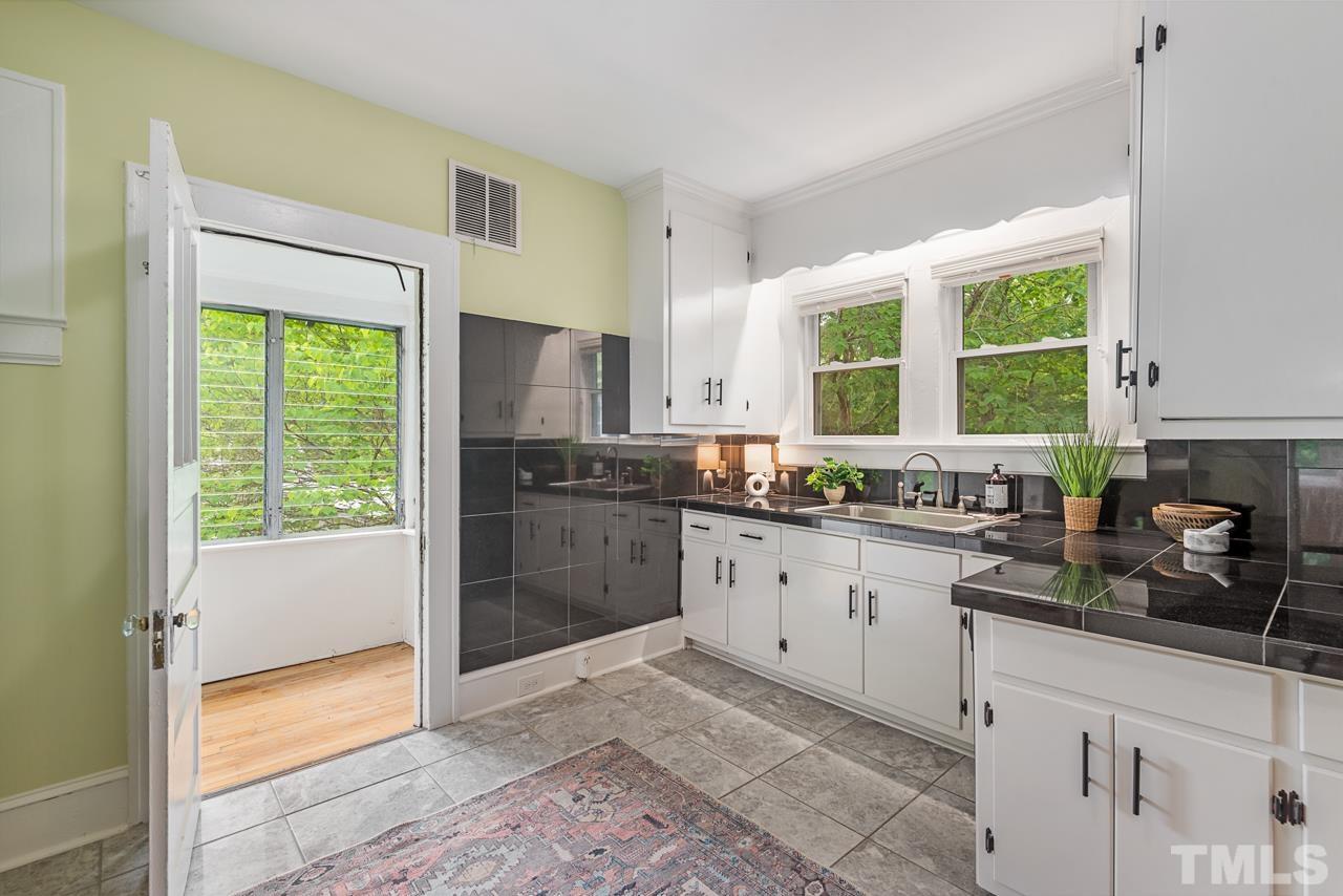 2201 University Drive Durham, NC 27707 - Photo 16 of 43 a kitchen with granite countertop a stove a sink and a refrigerator