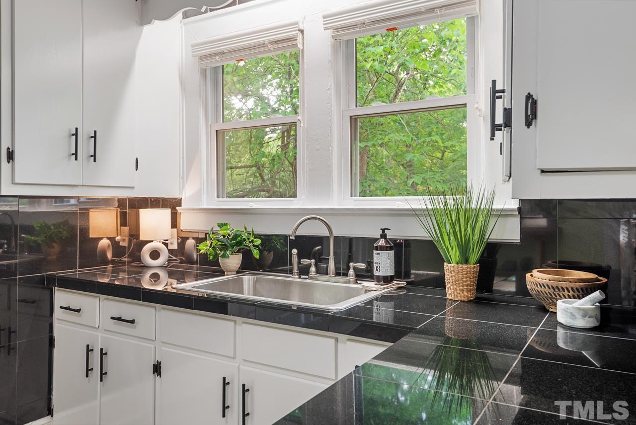 2201 University Drive Durham, NC 27707 - Photo 17 of 43 a kitchen with stainless steel appliances a sink a window and cabinets