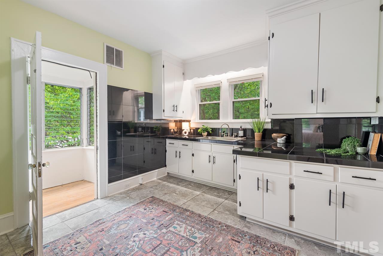 2201 University Drive Durham, NC 27707 - Photo 18 of 43 a kitchen with granite countertop a stove a sink and a refrigerator