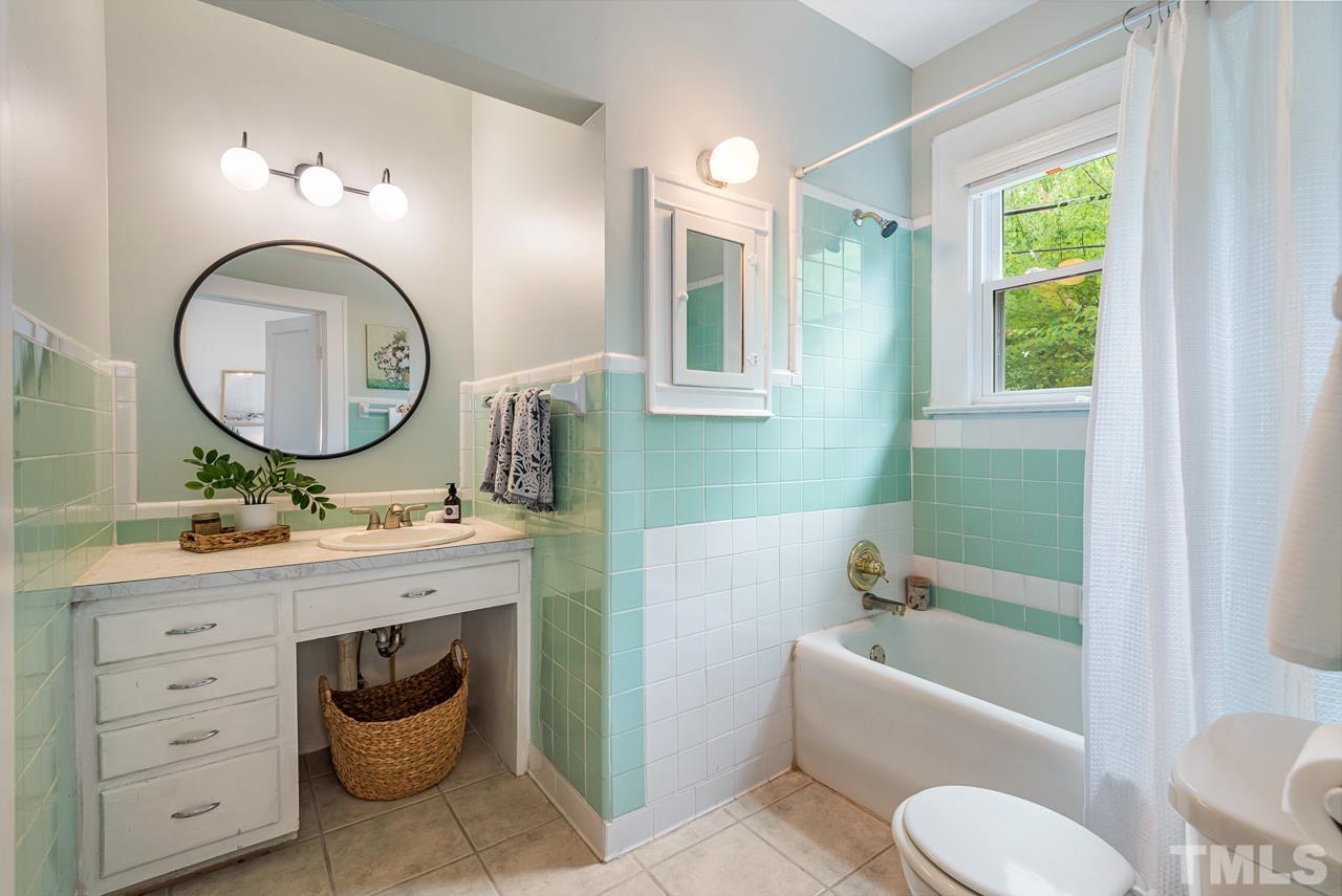 2201 University Drive Durham, NC 27707 - Photo 29 of 43 a bathroom with a toilet a sink and a mirror