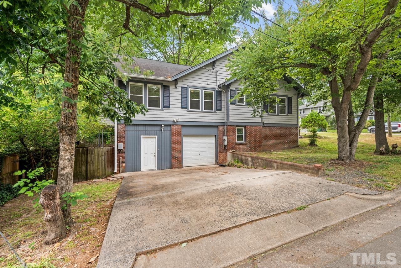 2201 University Drive Durham, NC 27707 - Photo 42 of 43 a front view of a house with a garden and trees