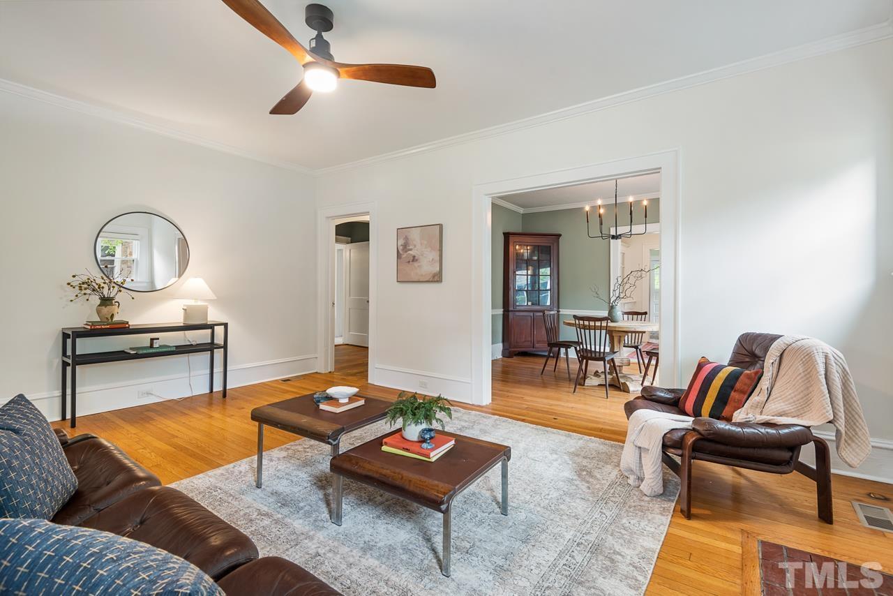 2201 University Drive Durham, NC 27707 - Photo 6 of 43 a living room with furniture a rug and a chandelier