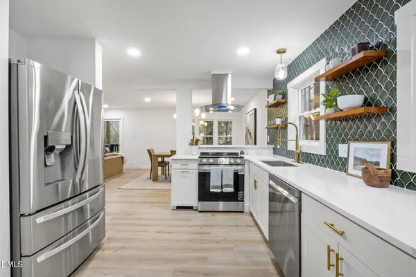 a view of a refrigerator in kitchen and wooden floor