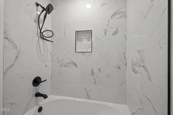 a view of room with a ceiling fan and window