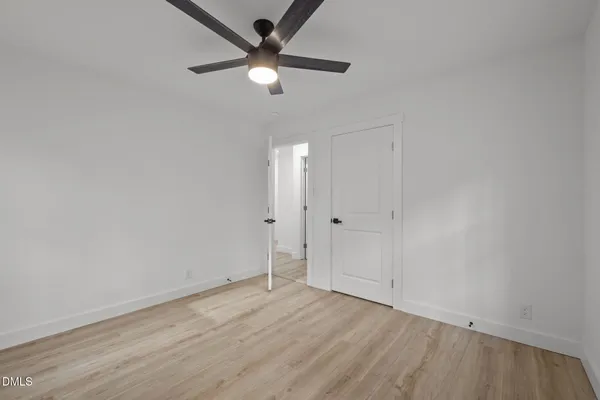 a living room with furniture kitchen view and a wooden floor