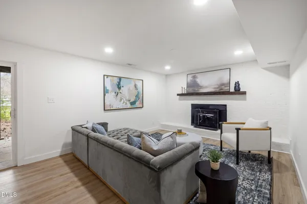 a big room with wooden floor and furniture