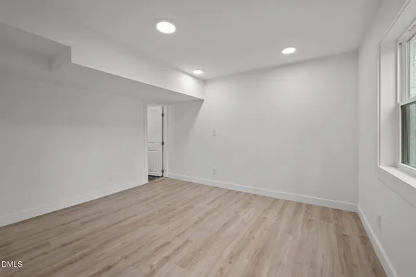 a view of a house with a yard and large tree