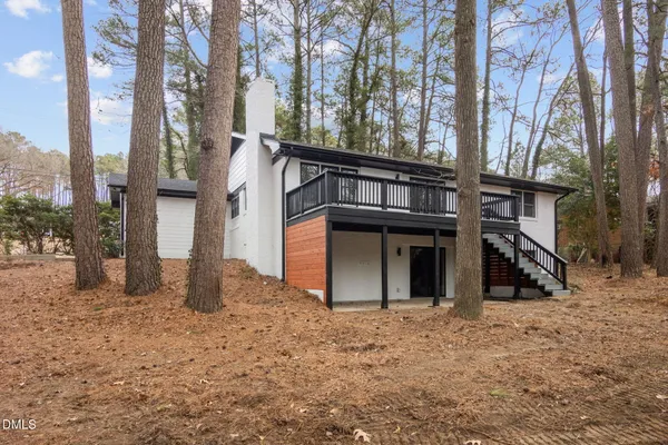 a view of a house with a yard and tree s