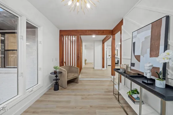 a view of an entryway with wooden floor and windows