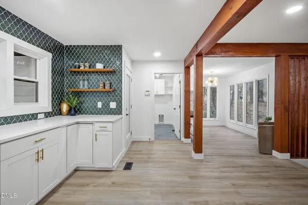 a kitchen with granite countertop white cabinets and white appliances