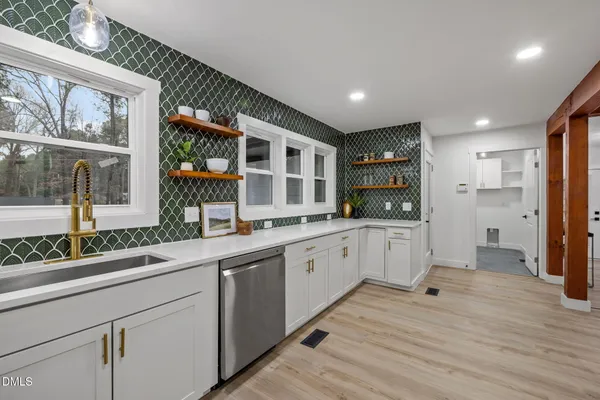 a kitchen with stainless steel appliances a sink stove and refrigerator