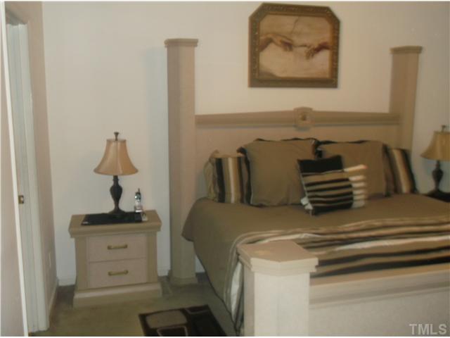 2204 Tucca Way Raleigh, NC 27604 - Photo 12 of 17 a bedroom with a bed and a lamp on dresser