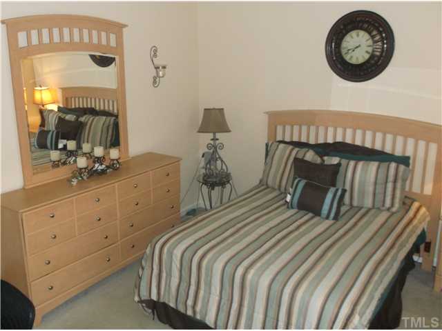 2204 Tucca Way Raleigh, NC 27604 - Photo 14 of 17 a bedroom with a bed and a large mirror on the dresser