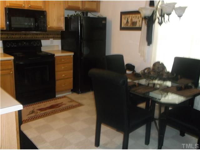 2204 Tucca Way Raleigh, NC 27604 - Photo 7 of 17 a kitchen with a table and chairs in it