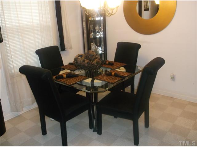 2204 Tucca Way Raleigh, NC 27604 - Photo 8 of 17 a dining room with furniture and a mirror