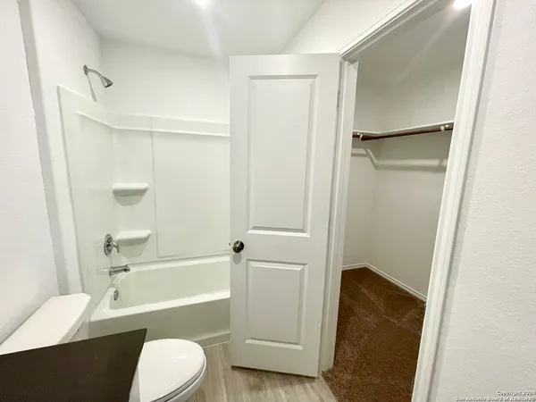 a bathroom with a toilet and a bathtub