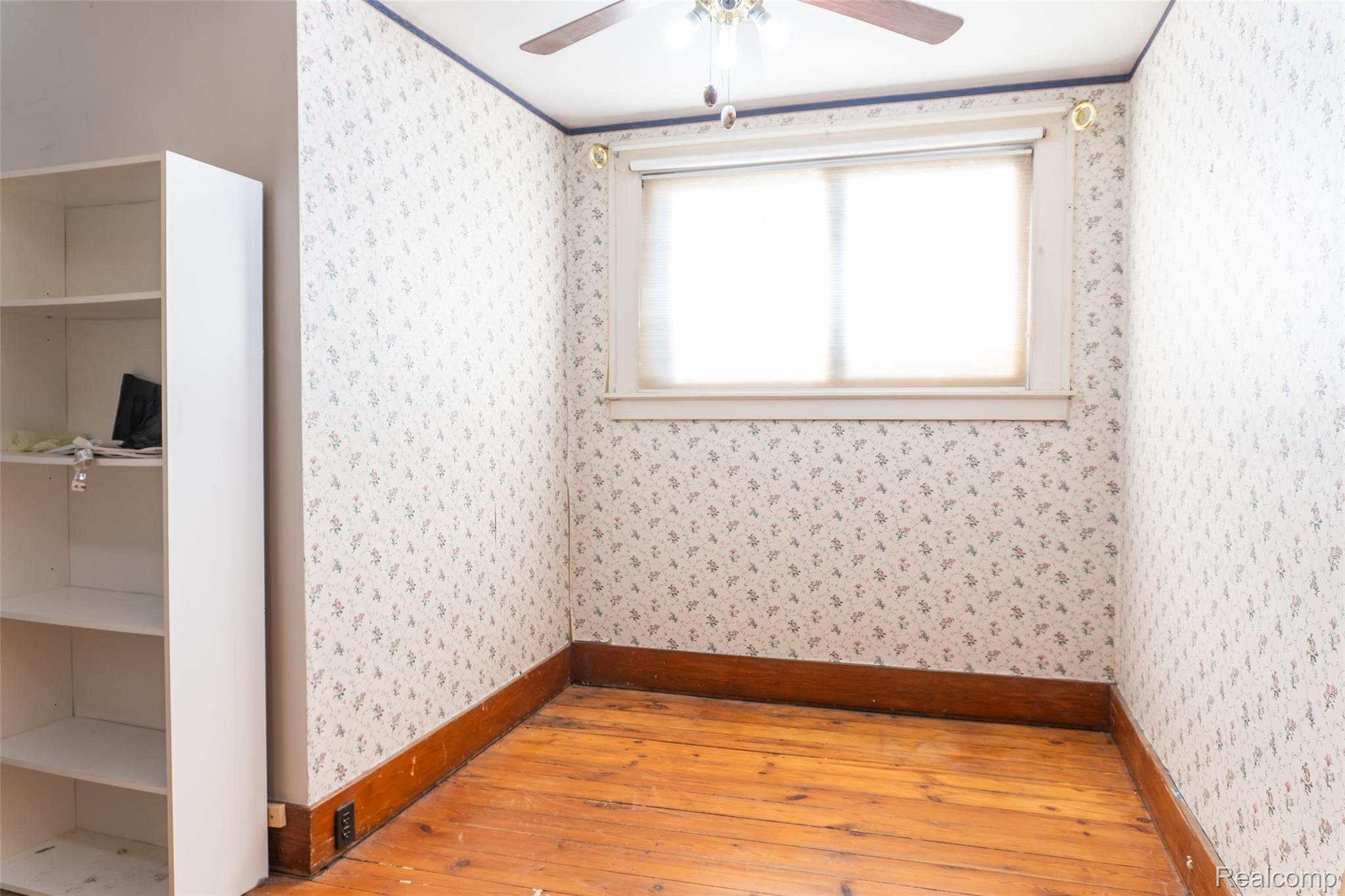 1846 North Gulley Road Dearborn, MI 48128 - Photo 18 of 32 Spare room featuring light wood-style flooring, a ceiling fan, and wallpapered walls