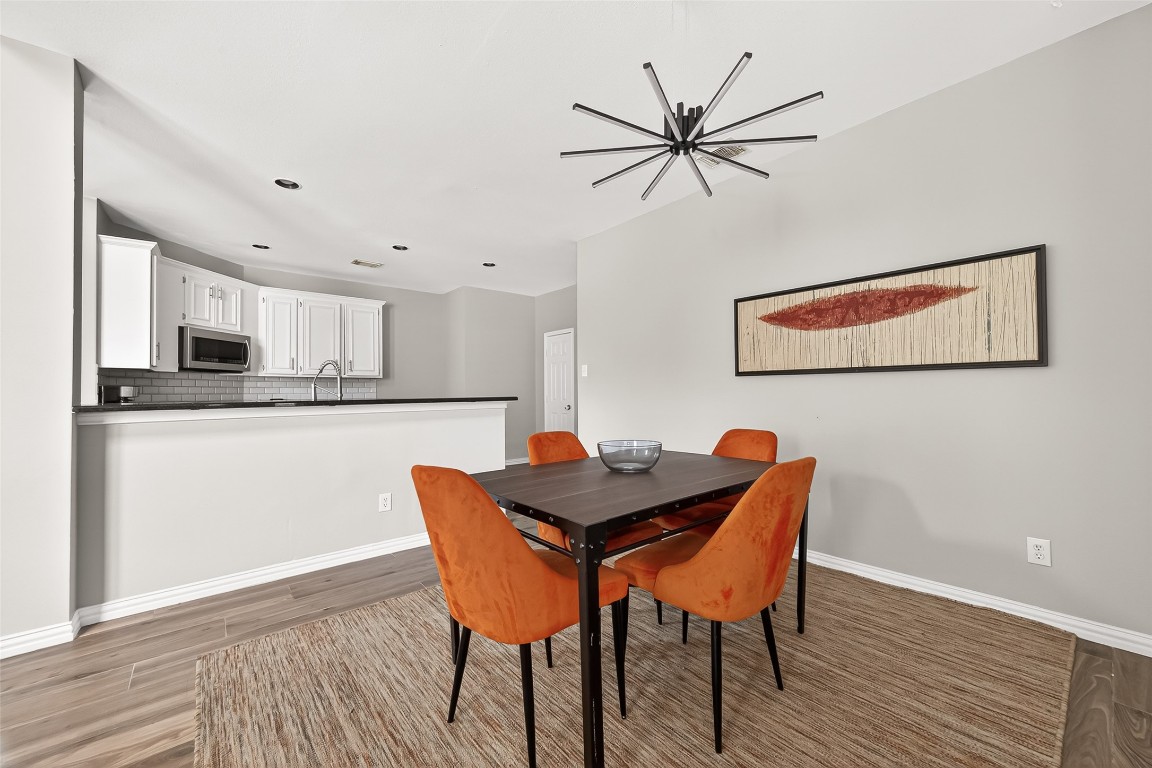 25507 Lyon Springs Court Spring, TX 77373 - Photo 12 of 39 a view of a dining room with furniture and wooden floor