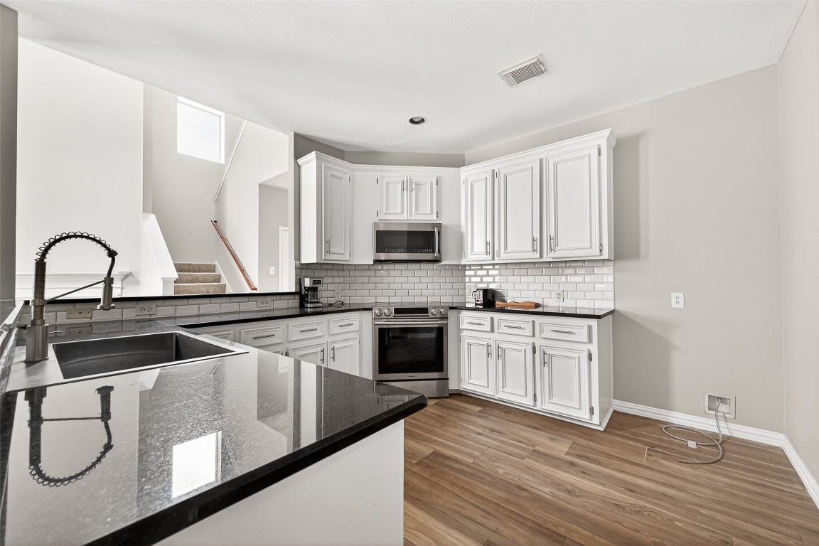 25507 Lyon Springs Court Spring, TX 77373 - Photo 13 of 39 a kitchen with appliances a sink and cabinets