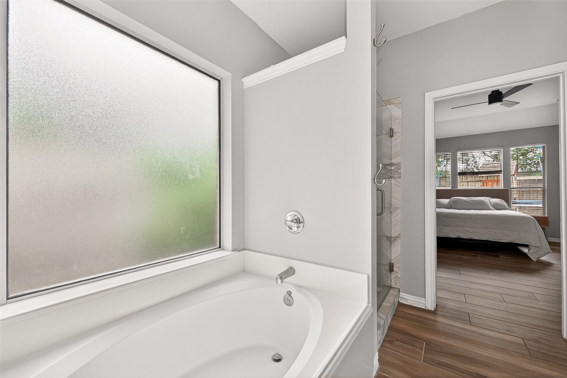 25507 Lyon Springs Court Spring, TX 77373 - Photo 26 of 39 a bathroom with a bathtub and a shower