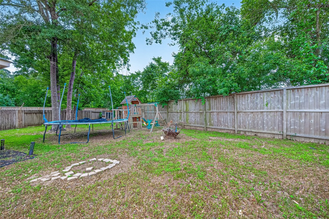 25507 Lyon Springs Court Spring, TX 77373 - Photo 36 of 39 a view of a backyard with a garden and entertaining space