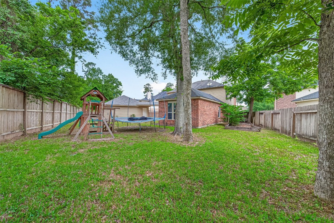 25507 Lyon Springs Court Spring, TX 77373 - Photo 38 of 39 a view of a house with backyard and a tree