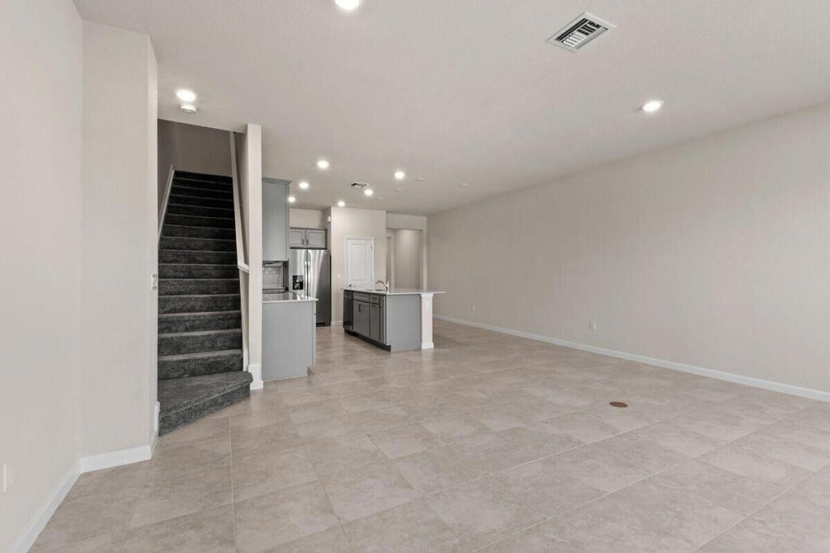 1805 Southeast Ocean Cove Way Stuart, FL 34996 - Photo 11 of 23 an empty room with a kitchen and entryway