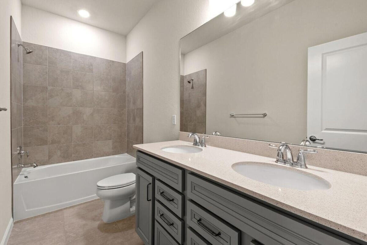 1805 Southeast Ocean Cove Way Stuart, FL 34996 - Photo 15 of 23 a bathroom with a granite countertop sink a toilet and shower