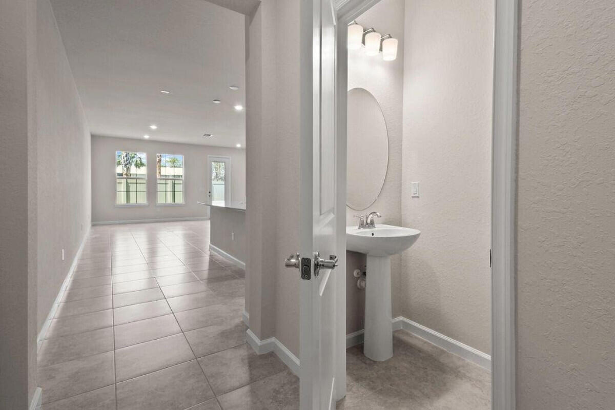 1805 Southeast Ocean Cove Way Stuart, FL 34996 - Photo 2 of 23 a view of a hallway with windows and chandelier