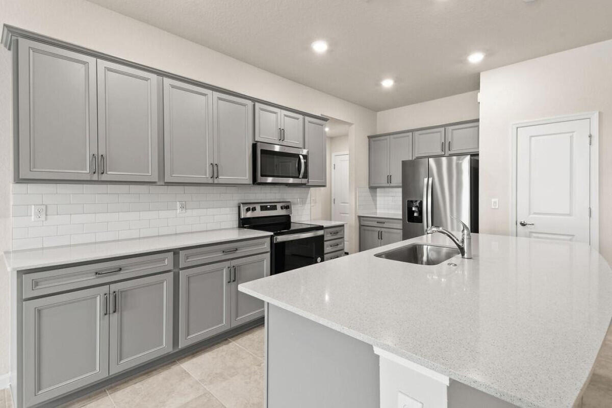 1805 Southeast Ocean Cove Way Stuart, FL 34996 - Photo 10 of 23 a kitchen with stainless steel appliances a refrigerator stove microwave and sink