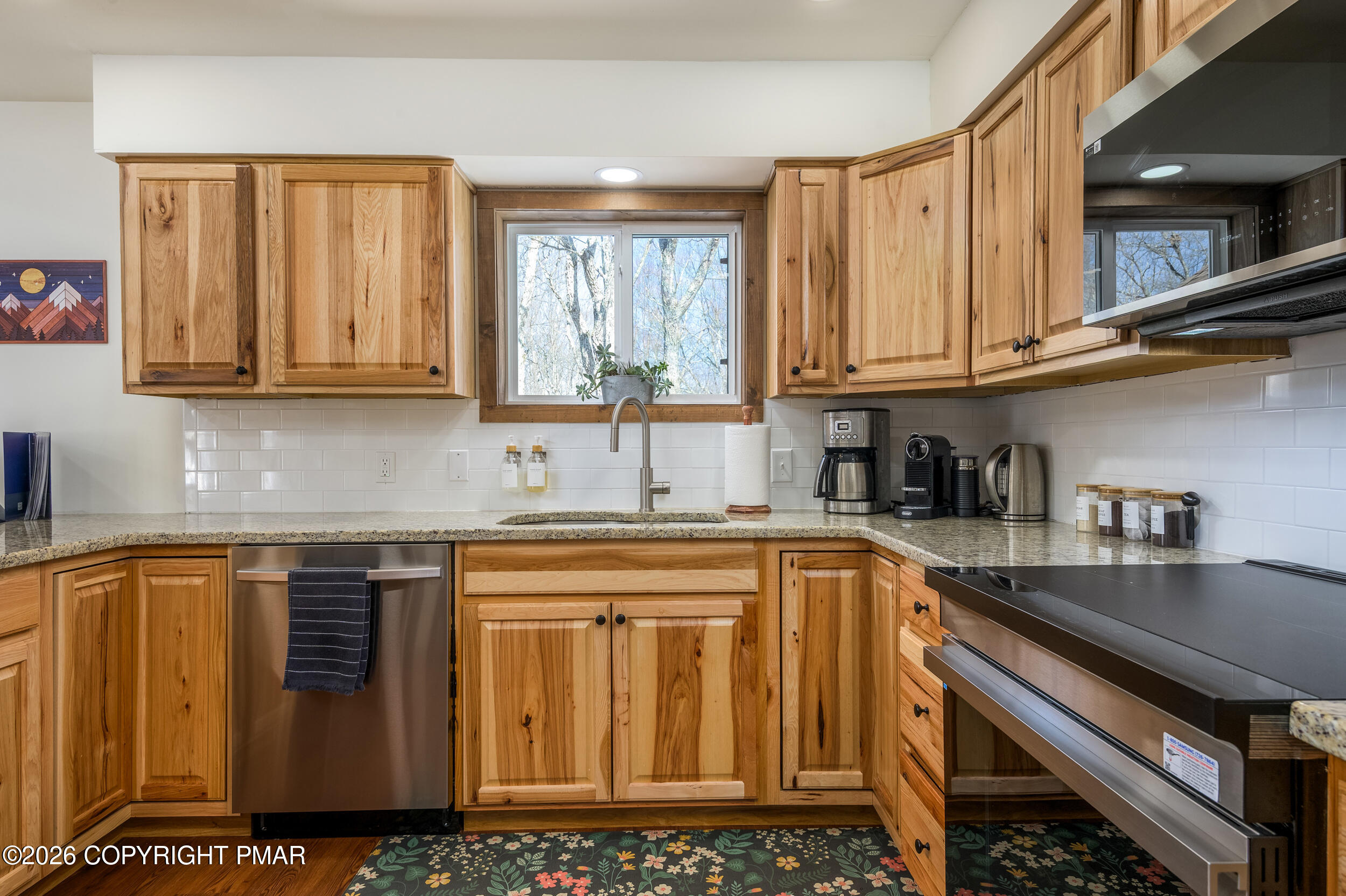 2206 Chatham Drive Bushkill, PA 18324 - Photo 24 of 45 a kitchen with stainless steel appliances granite countertop a sink stove and cabinets