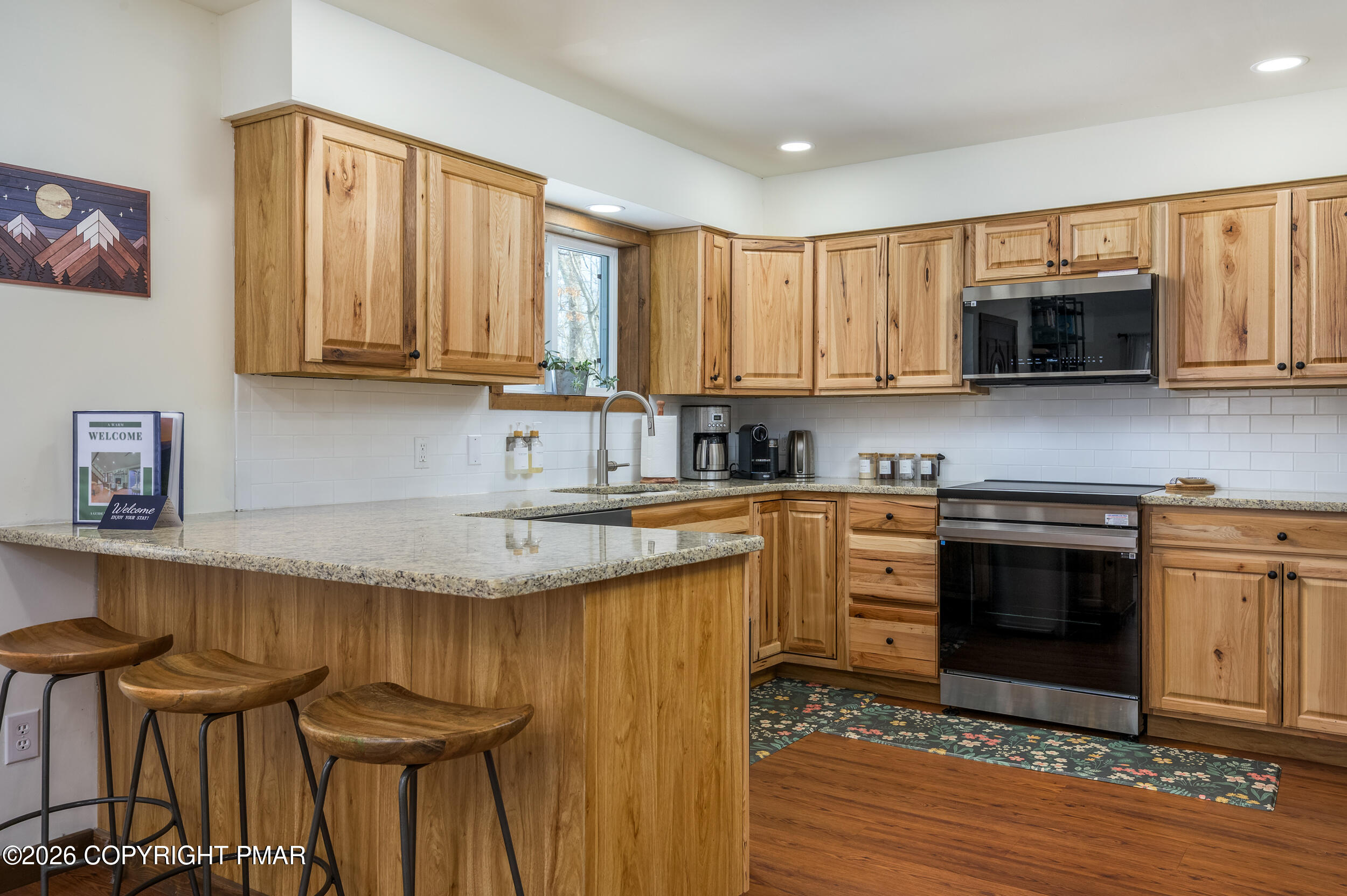 2206 Chatham Drive Bushkill, PA 18324 - Photo 5 of 45 a kitchen with granite countertop a stove a sink and a microwave