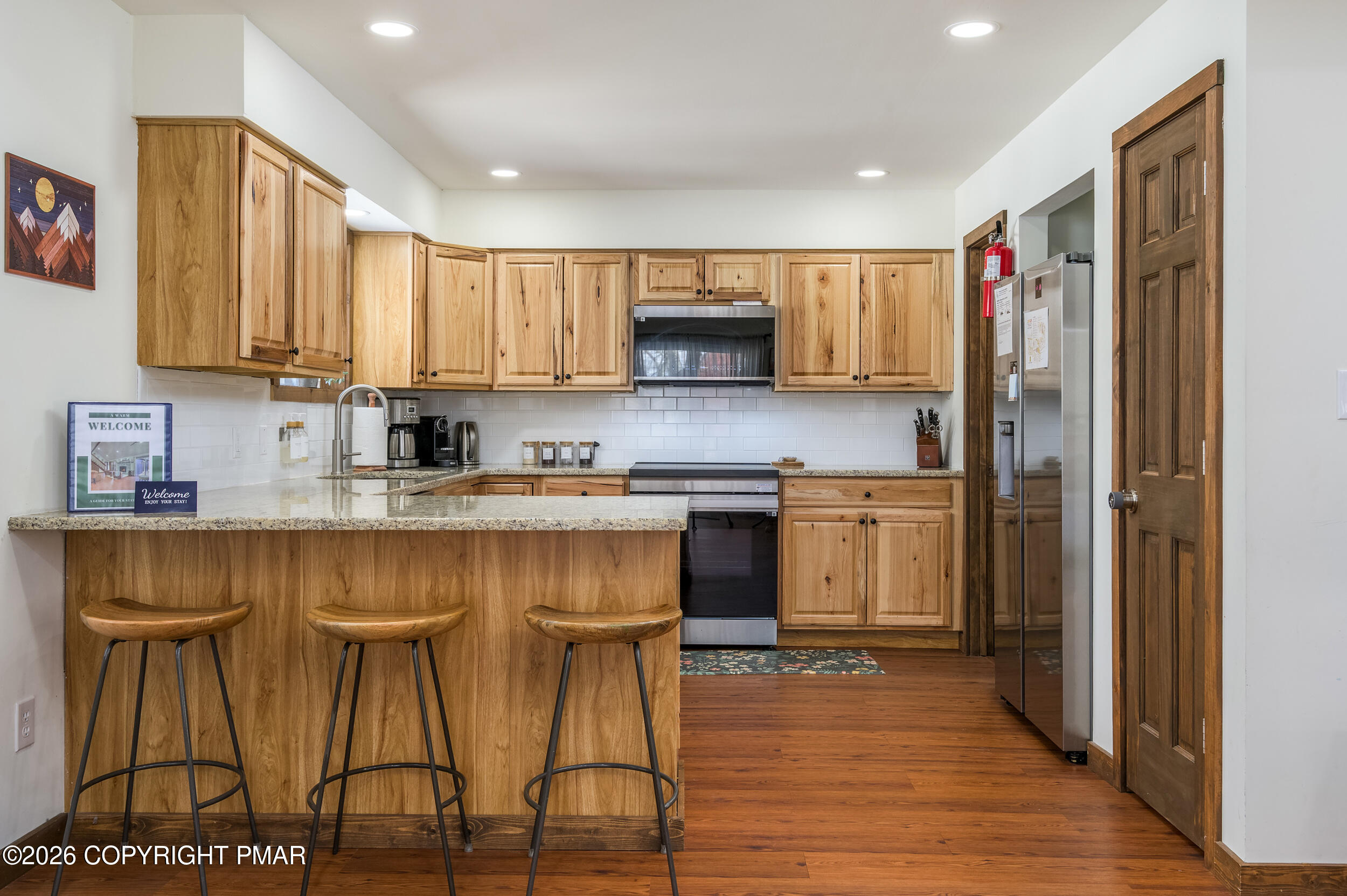 2206 Chatham Drive Bushkill, PA 18324 - Photo 6 of 45 a kitchen with stainless steel appliances granite countertop a stove a sink and a refrigerator