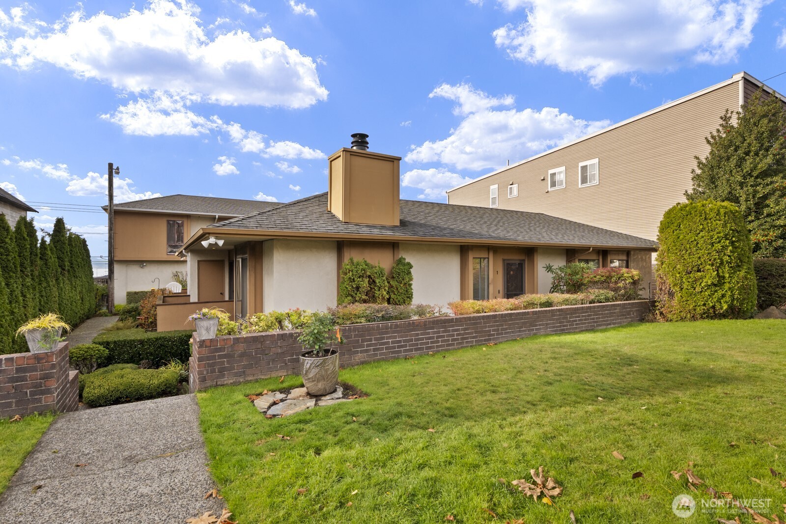 2510 Rucker Avenue, Unit 1 Everett, WA 98201 - Photo 3 of 34 a front view of a house with a garden and patio