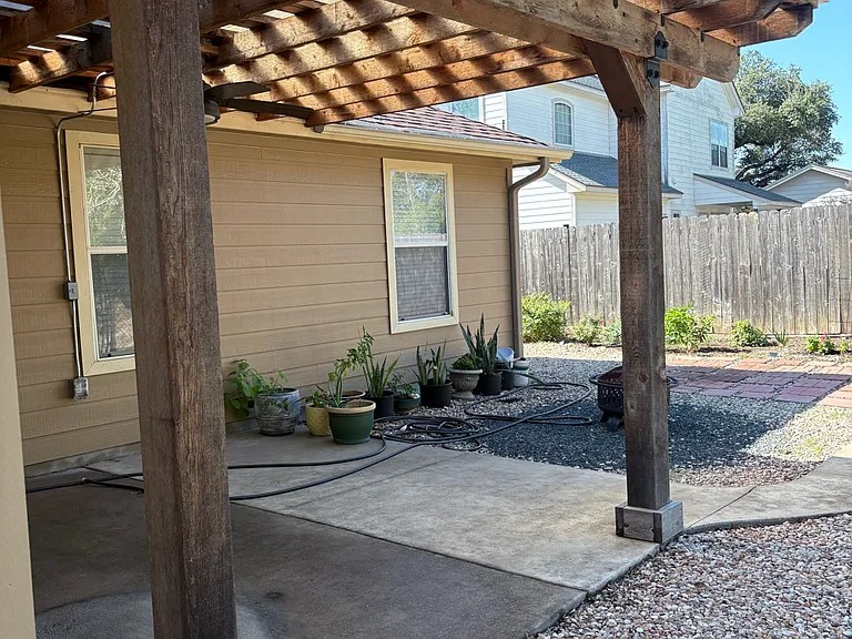 430 Summit Ridge Drive North Point Venture, TX 78645 - Photo 20 of 26 A spacious backyard patio offers an ideal space for outdoor relaxation and entertainment.