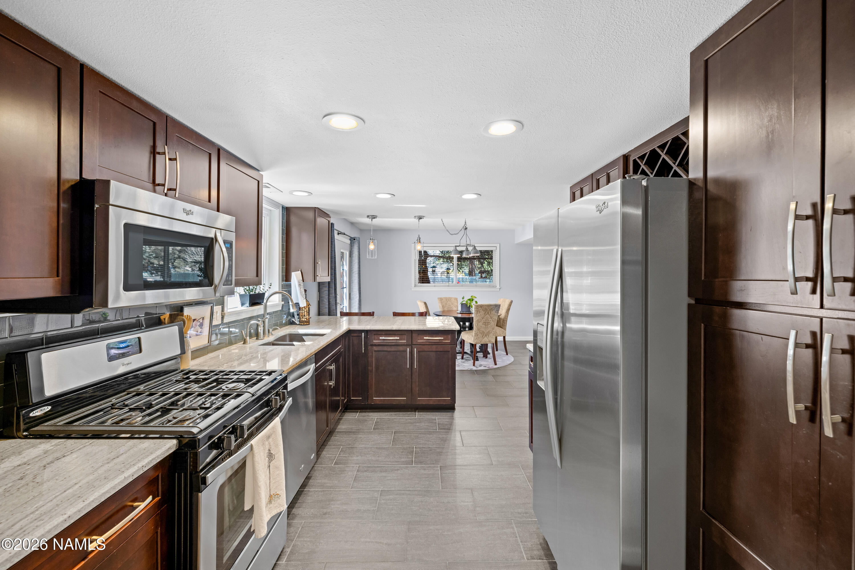 2536 East Eva Loop Flagstaff, AZ 86004 - Photo 12 of 37 a kitchen with stainless steel appliances granite countertop a stove top oven a refrigerator and a sink