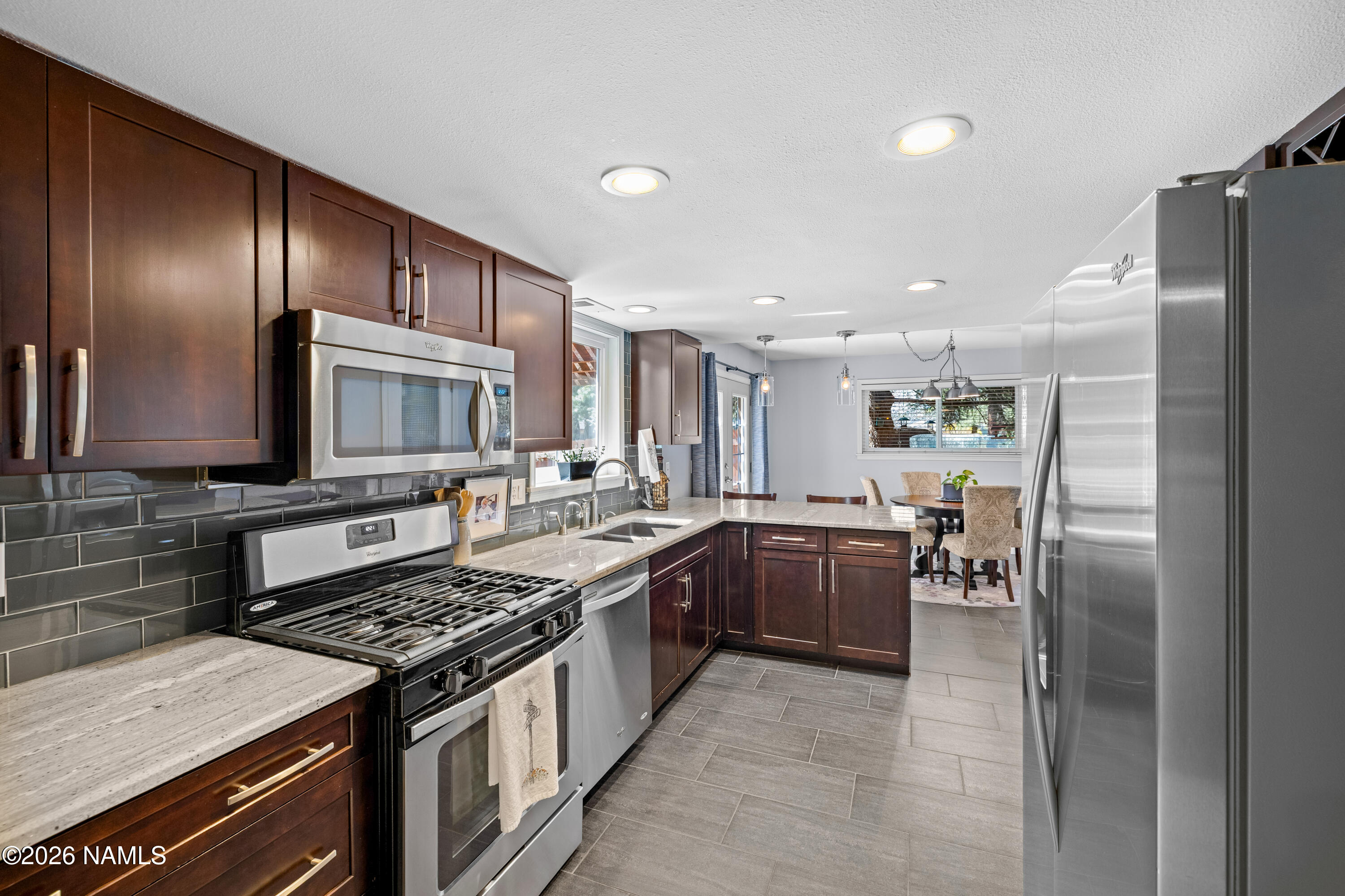 2536 East Eva Loop Flagstaff, AZ 86004 - Photo 13 of 37 a kitchen with stainless steel appliances granite countertop a stove and a refrigerator