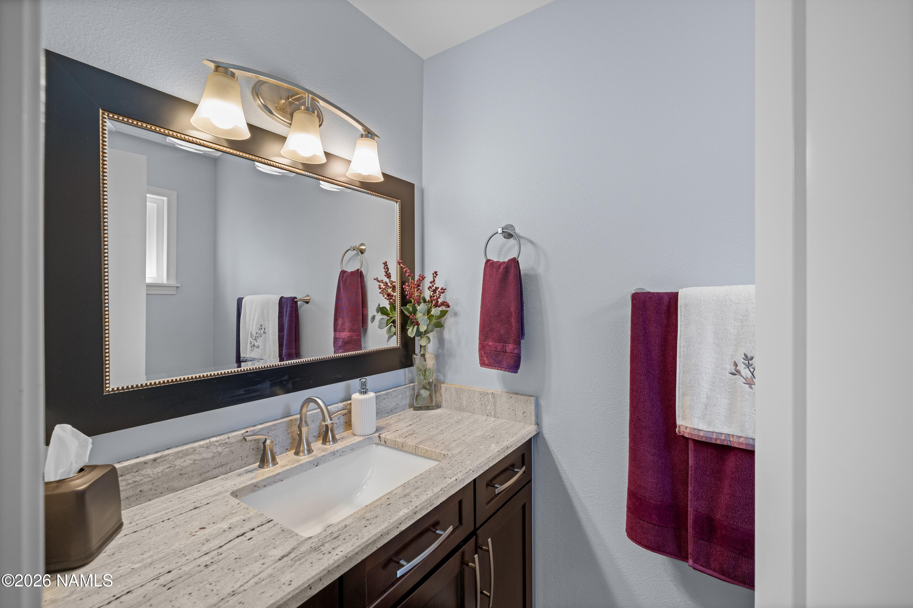 2536 East Eva Loop Flagstaff, AZ 86004 - Photo 16 of 37 a bathroom with a granite countertop double vanity sink and a mirror