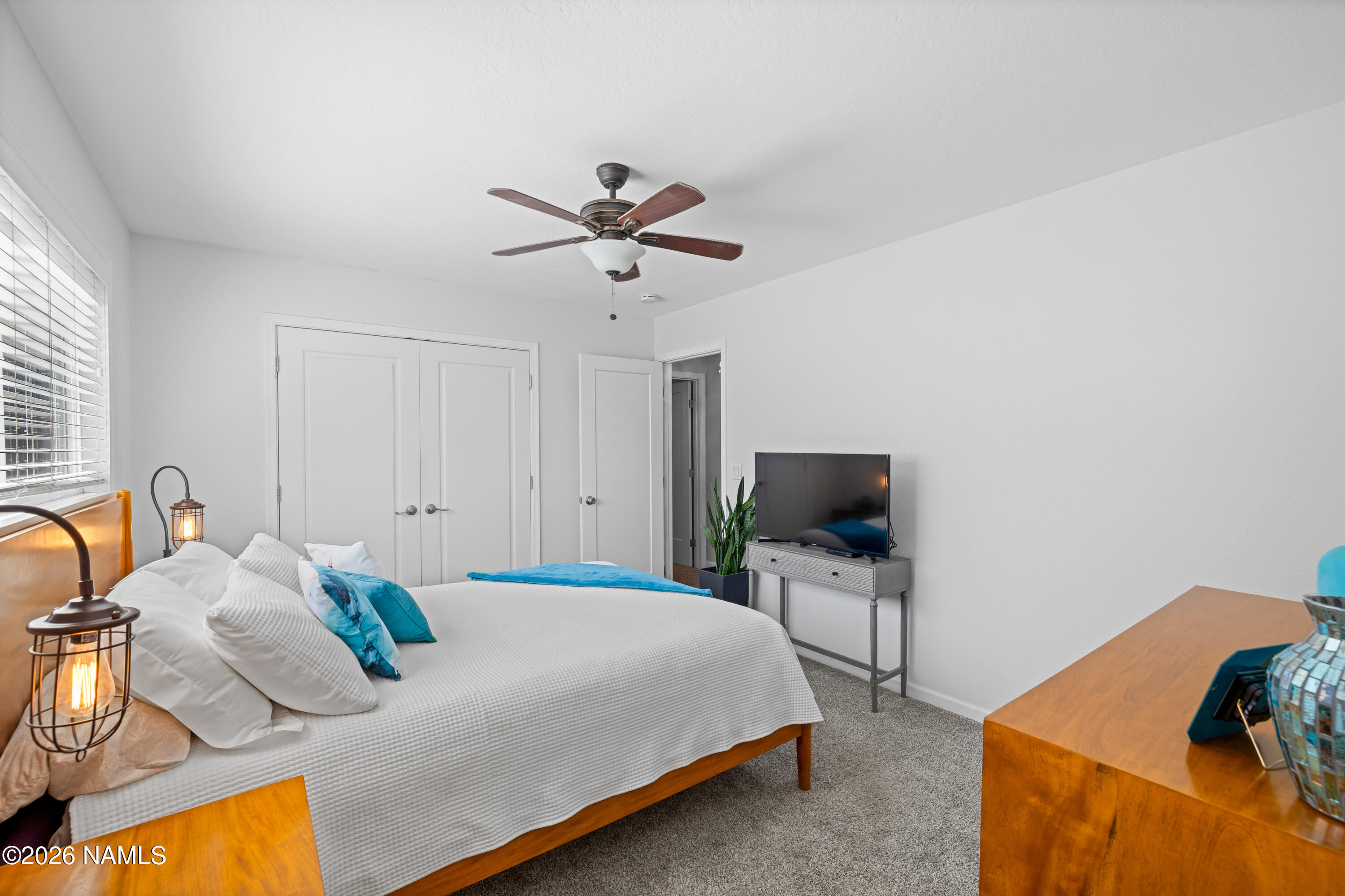 2536 East Eva Loop Flagstaff, AZ 86004 - Photo 19 of 37 a bedroom with a bed and a flat screen tv