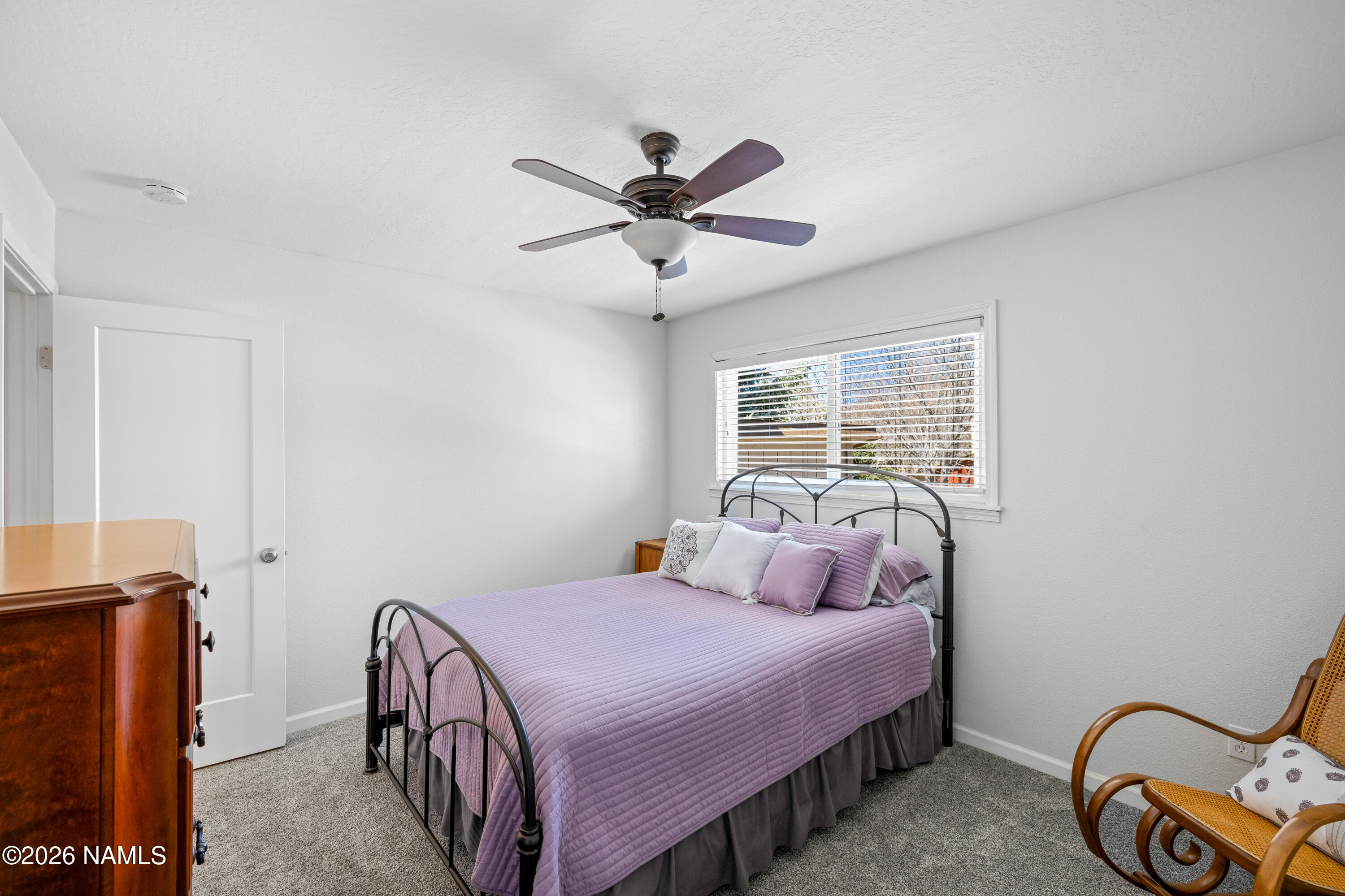 2536 East Eva Loop Flagstaff, AZ 86004 - Photo 23 of 37 a bedroom with a bed and a chandelier