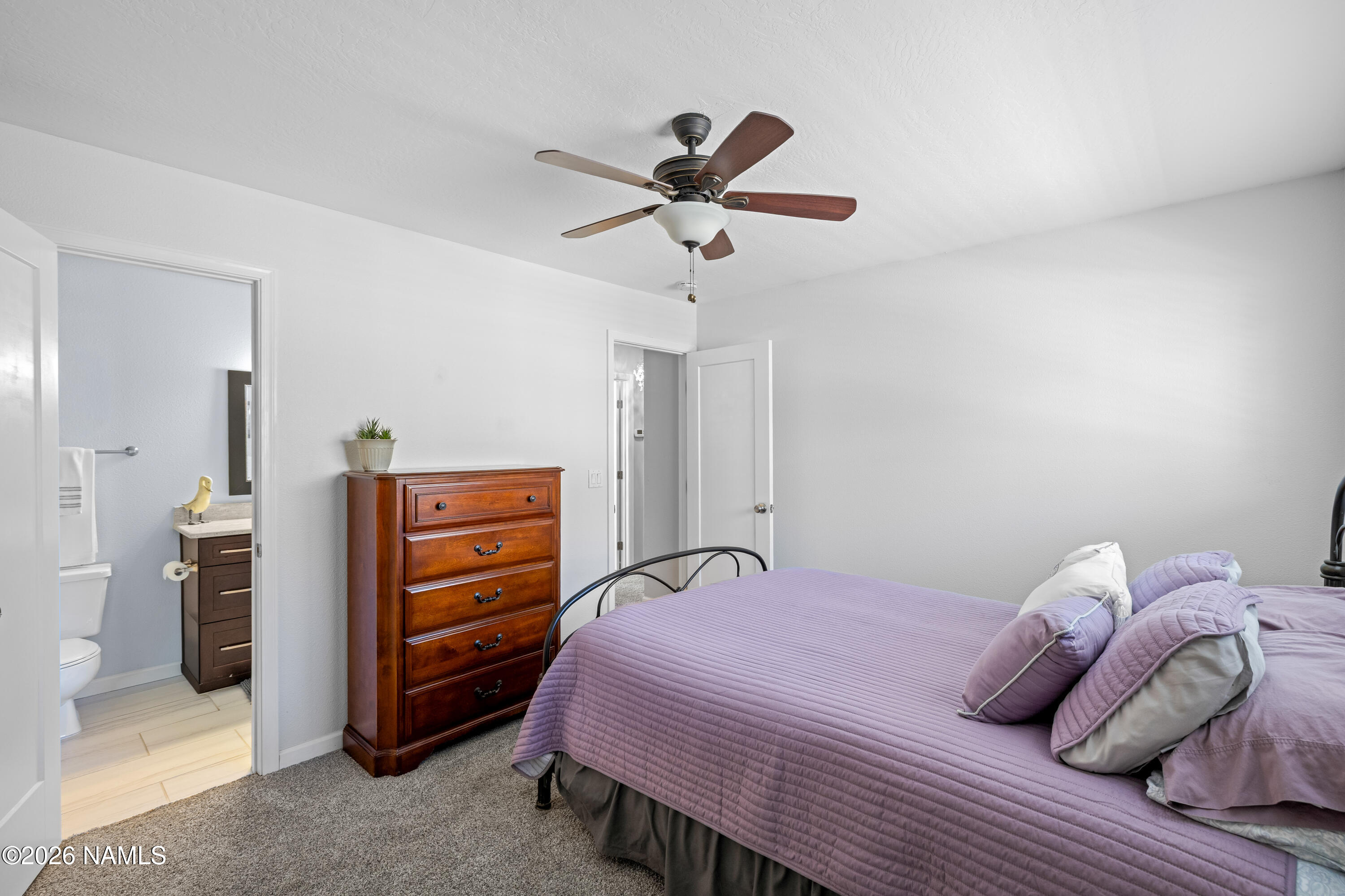2536 East Eva Loop Flagstaff, AZ 86004 - Photo 24 of 37 a bedroom with a bed and a chandelier