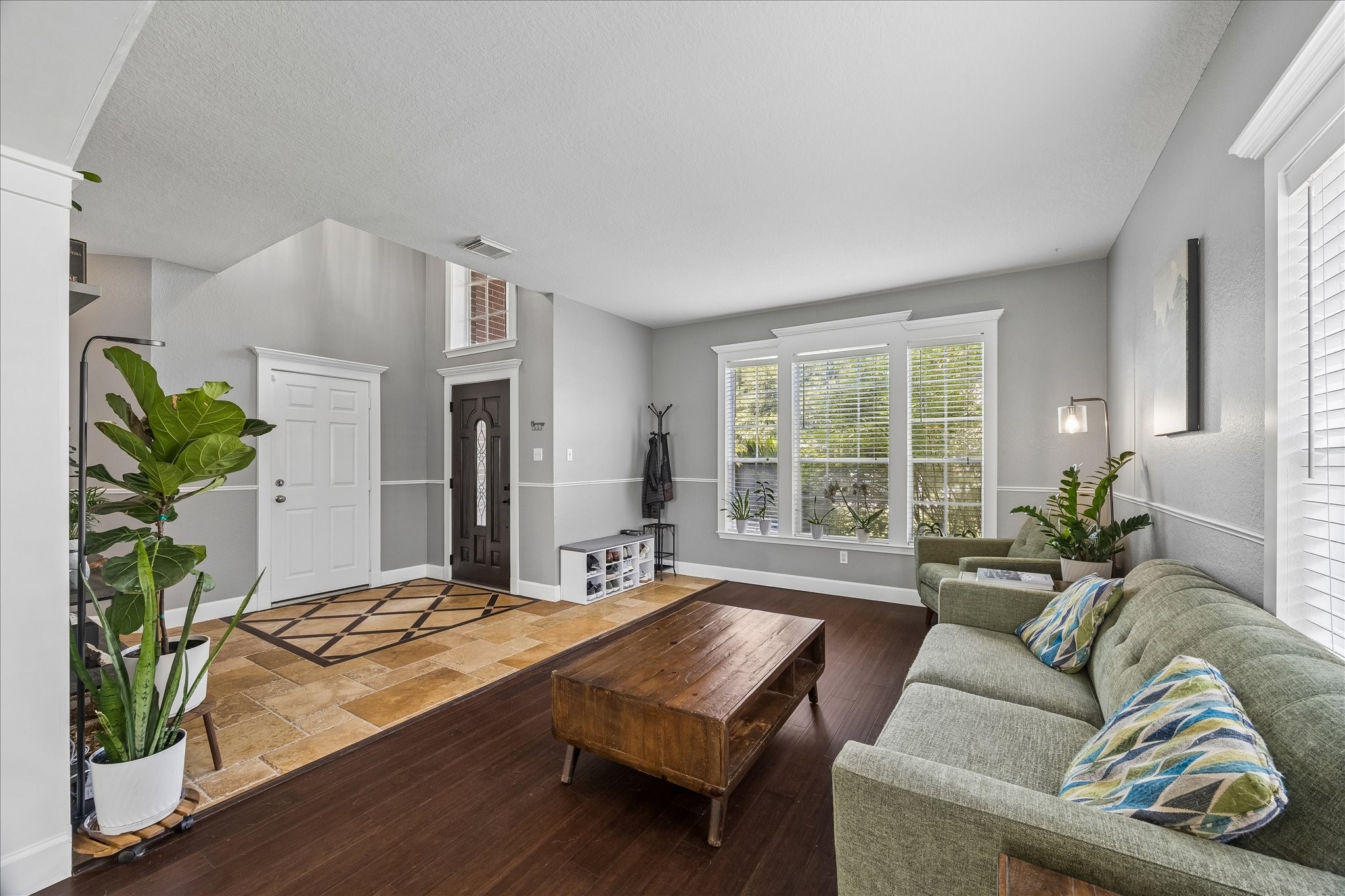 23234 Grand Rapids Lane Spring, TX 77373 - Photo 7 of 30 Spacious living area with soaring ceilings and rich wood flooring offers a warm, welcoming space just off the front entry.