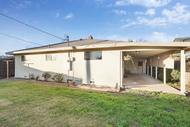 a view of a porch with a big yard and plants