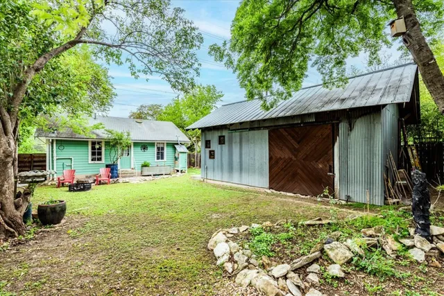 a view of a house with backyard porch and sitting area