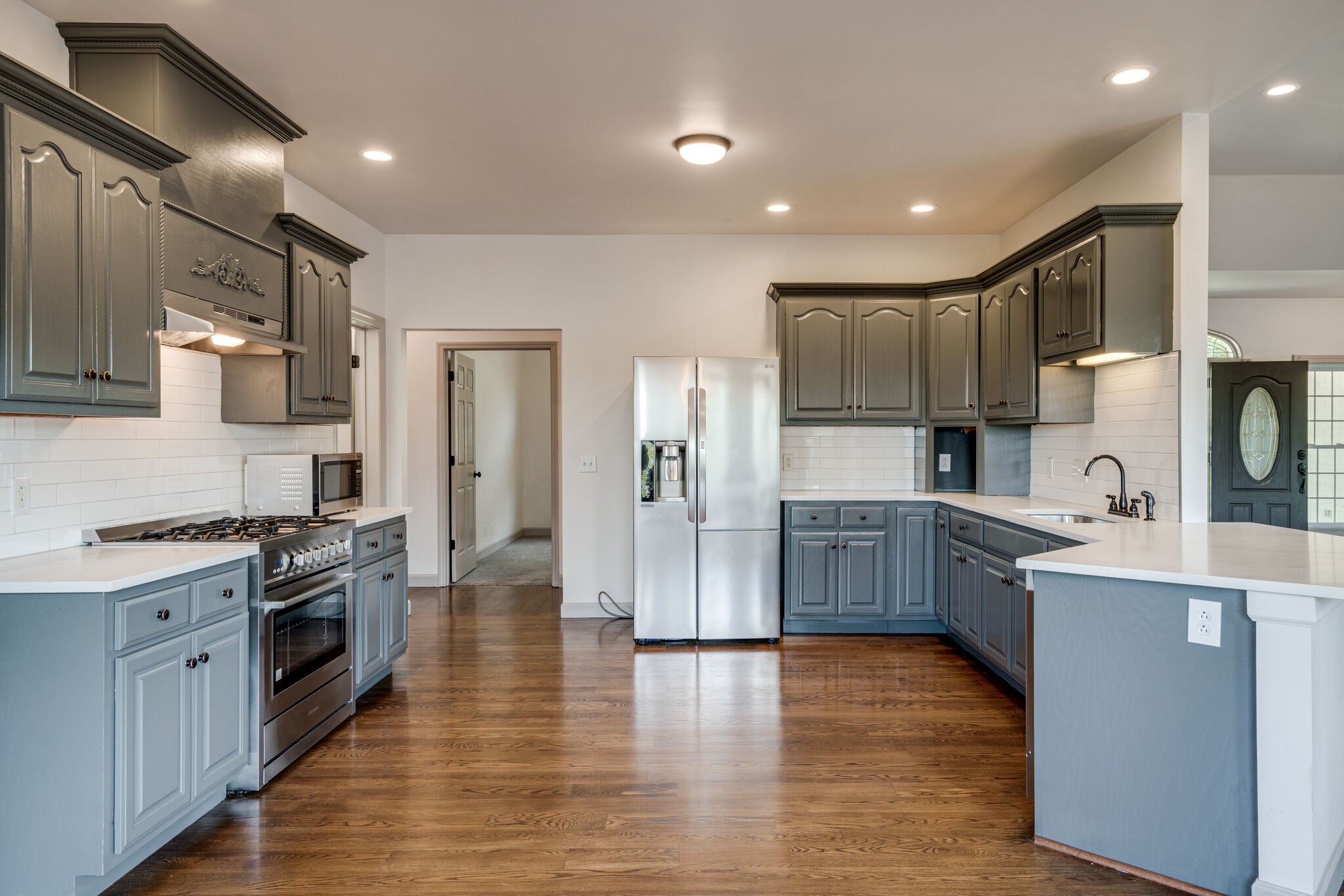 935 Barnes Road Antioch, TN 37013 - Photo 8 of 47 a large kitchen with cabinets wooden floor and stainless steel appliances