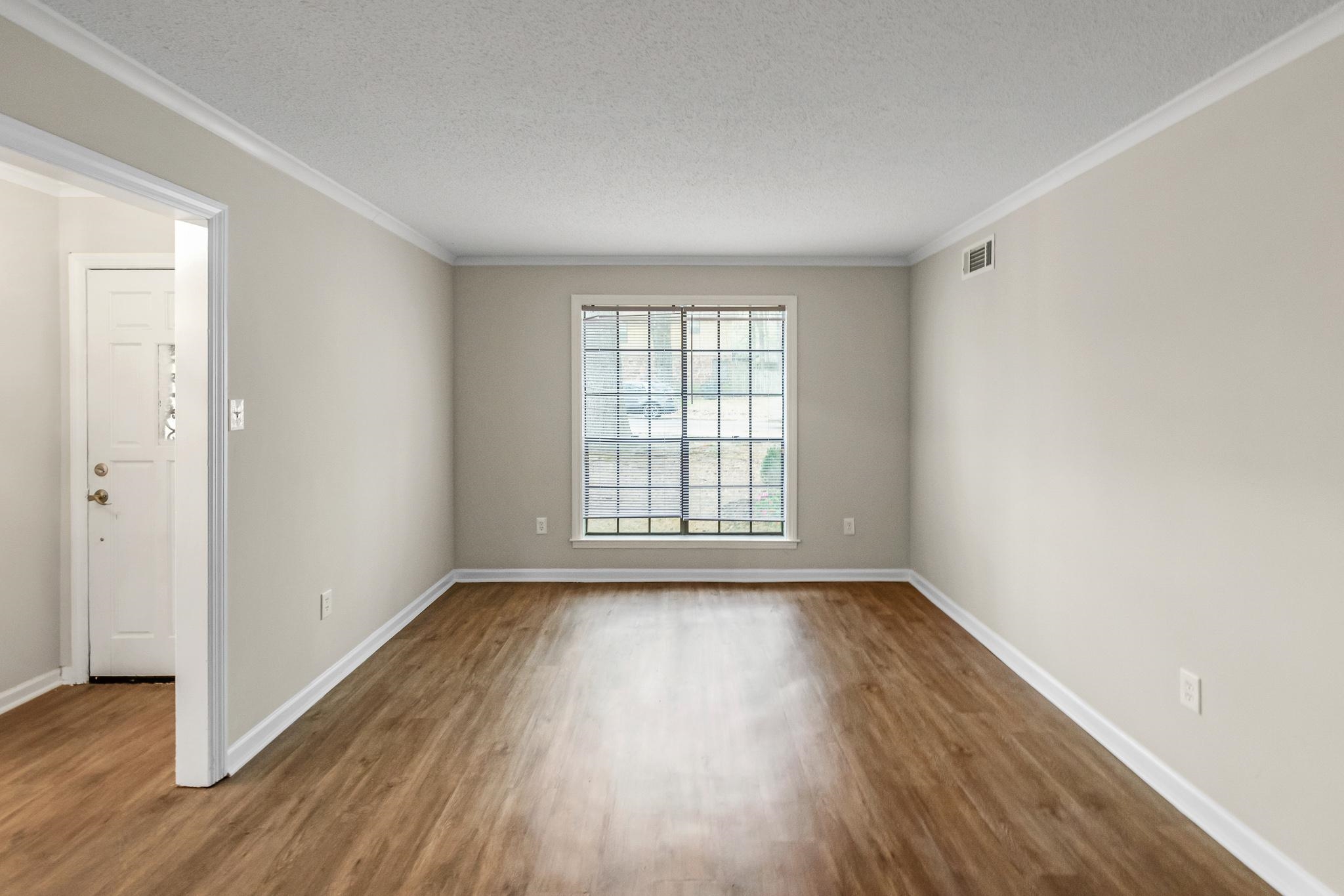 3036 Canyon Road Memphis, TN 38134 - Photo 11 of 24 a view of an empty room with wooden floor and a window